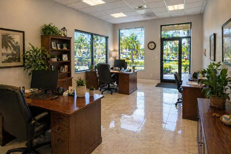 Office interior with desks, filing cabinets and tile flooring